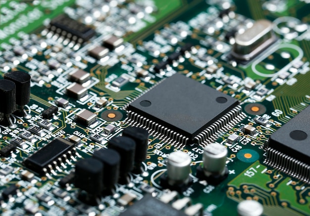 Closeup of electronic circuit board with CPU microchip electronic components background