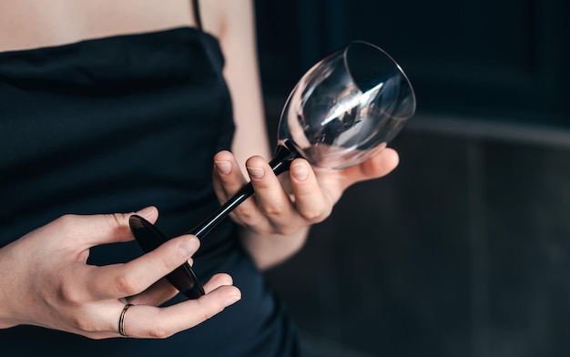 Closeup empty wine glass in female hands