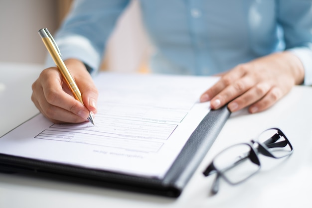 Closeup of entrepreneur making notes in document