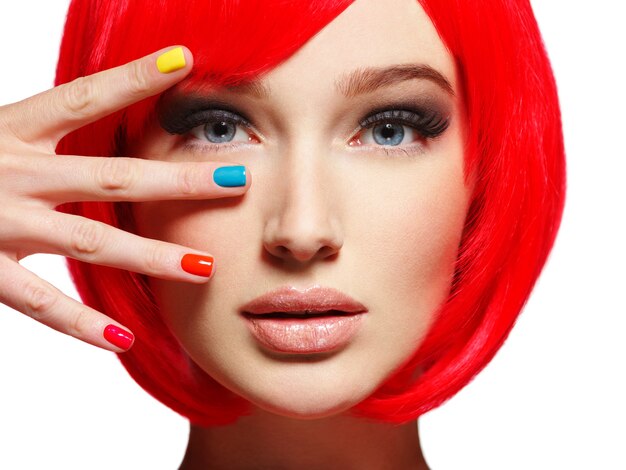 Closeup face of a beautiful  girl with bright multicolor nails.