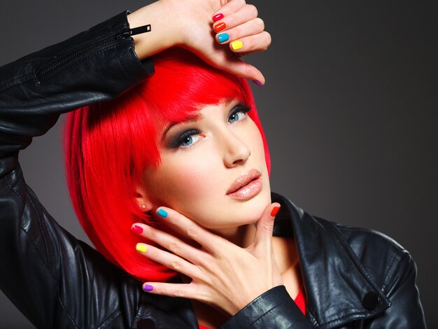 Closeup face of a beautiful  girl with bright multicolor nails.