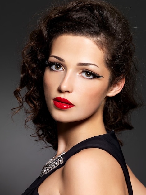 Closeup face of brunette woman with fashion makeup and red lips