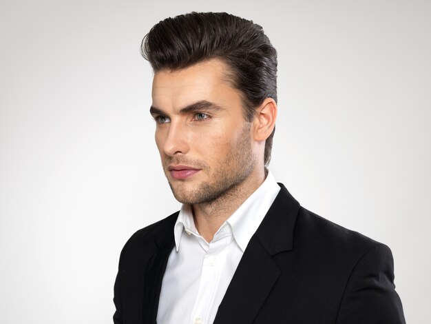 Closeup face of a fashion young businessman in black suit casual  poses at studio