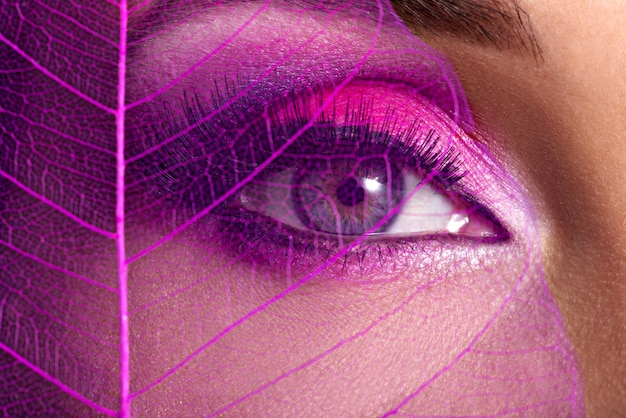 Closeup female eye with  beautiful fashion bright pink makeup 
