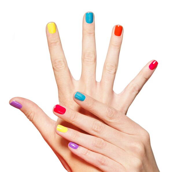 Closeup female hand with  multicolor nails over white.