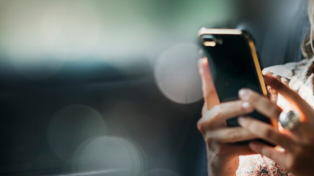 Closeup of female hands texting