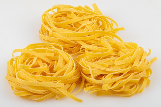 Closeup of Fettuccine under the lights against a white background