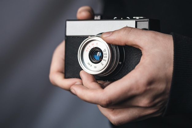 Closeup film retro camera in male hands