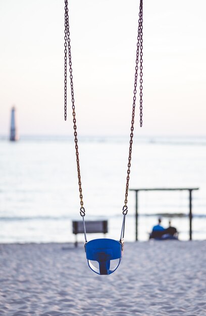 Closeup focus shot of swings at the beach