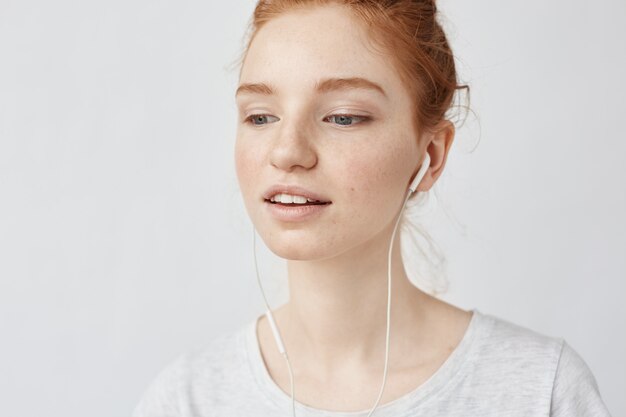 Closeup of foxy woman listening music in headphones enjoying.