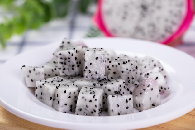 Closeup of fresh cubed dragon fruit on a white plate