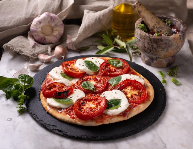 Closeup of a fresh pizza with mozzarella cheese tomatoes and basil