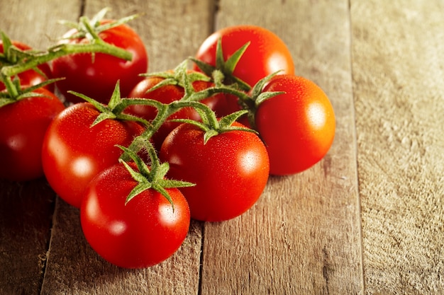Closeup of fresh tasty red tomatoes. Sunny daylight. Healthy food or italian food concept.