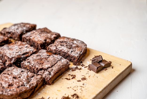 Closeup of freshly baked brownies on a wooden board