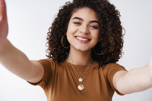 Free photo closeup friendly cheerful attractive girlfriend hold camera stretch arms taking selfie digital tablet talking boyfriend videocall smiling joyfully hugging friend standing white background