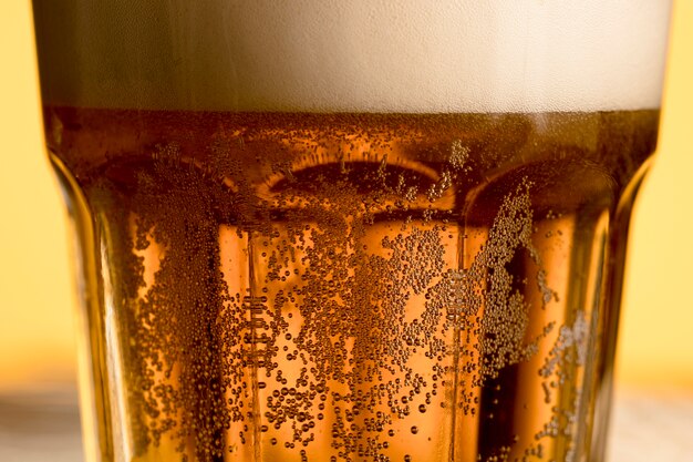 Closeup glass of cold beer with golden bubble 