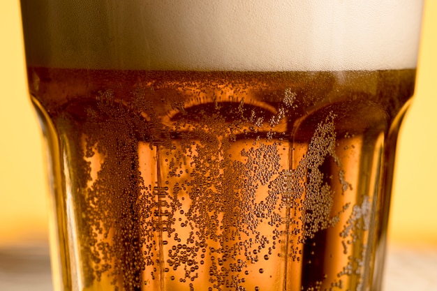 Closeup glass of cold beer with golden bubble 