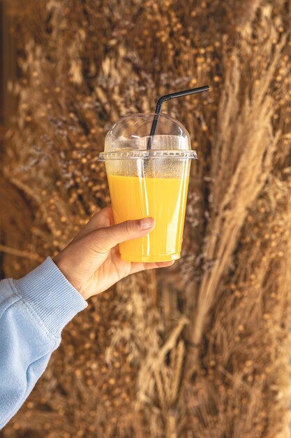 Free photo closeup a glass of orange juice in a female hand