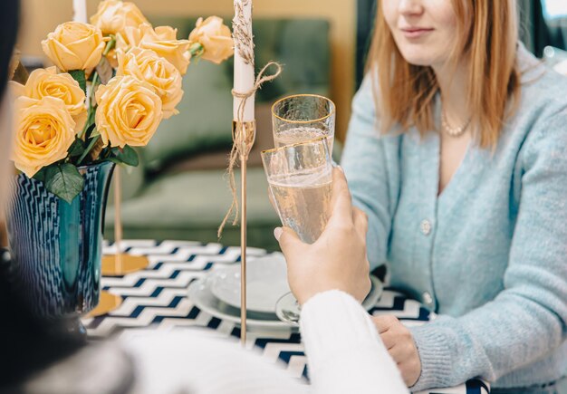 Closeup of glasses with champagne in female hands