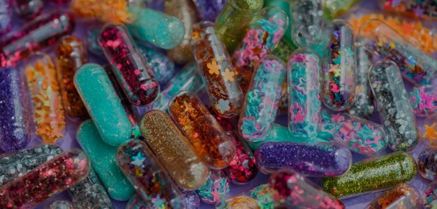 Closeup of glittery shimmery shiny pills capsule background