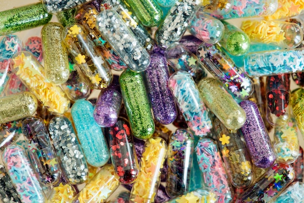 Closeup of glittery shimmery shiny pills capsule background