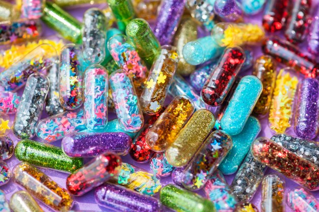 Closeup of glittery shimmery shiny pills capsule background