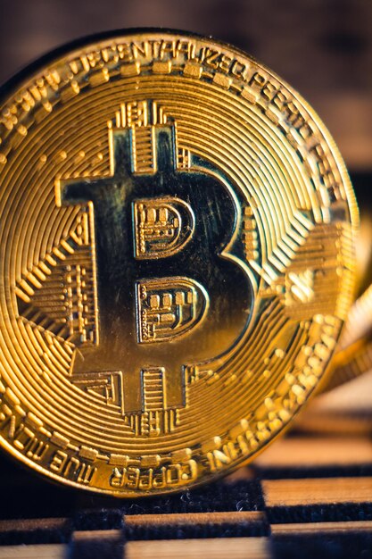 Closeup of a golden bitcoin on a blurry backgroun