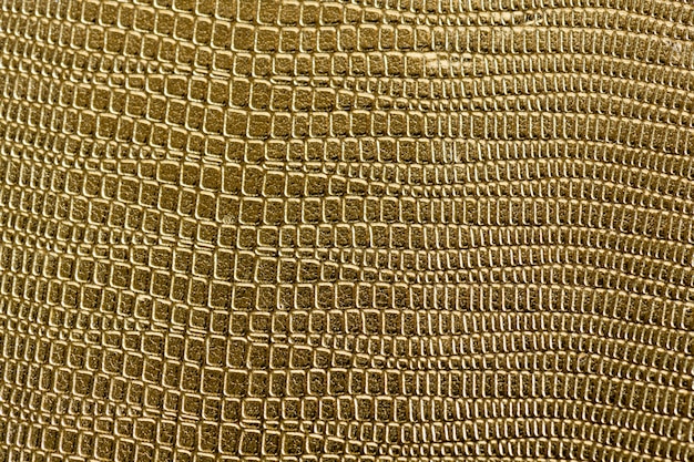 Closeup of golden scaly textured pattern background