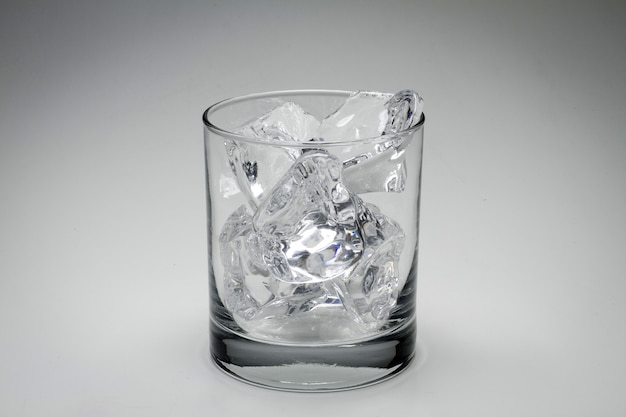 Closeup gray scale shot of a glass full of ice cubes isolated