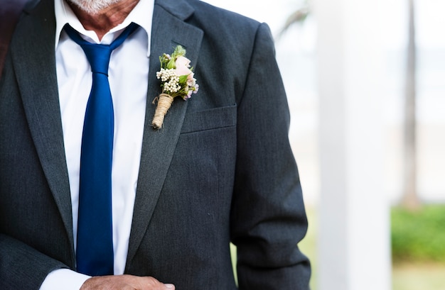 Closeup of groom boutonnière on suit lapel