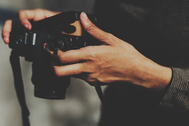 Closeup of hands checking film in camera