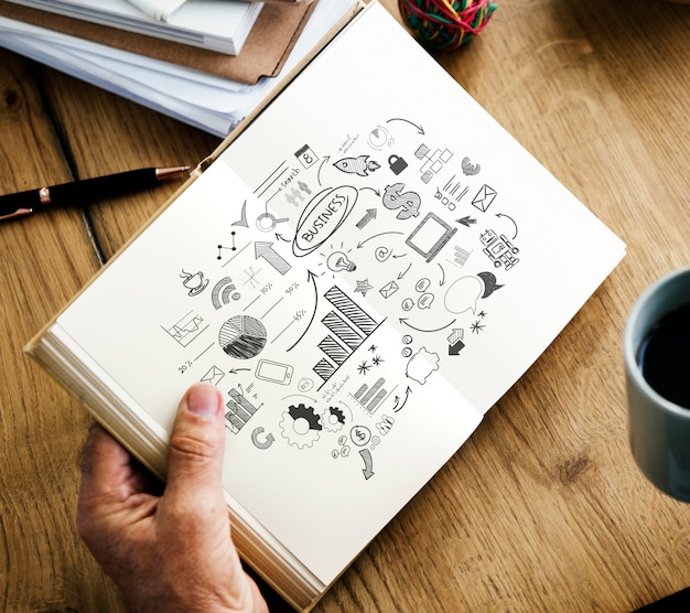 Closeup of hands holding open novel and coffee cup