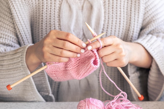 Closeup of hands knitting using circular needles