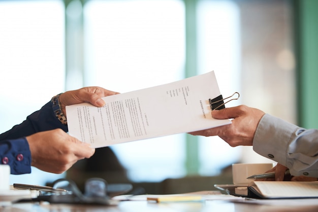 Free Photo closeup of hands passing the contract to unrecognizable businessman