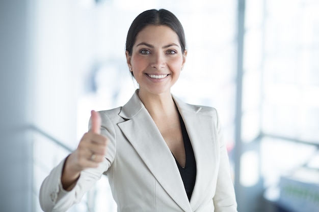 Макрофотография счастливый бизнес-леди показывает большой палец вверх