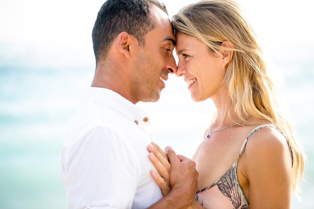 Closeup of Happy Couple Touching Foreheads by Sea