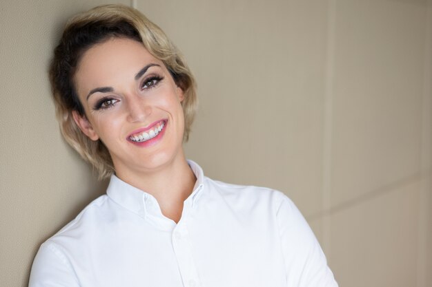 Closeup of Happy Middle-aged Woman Leaning on Wall