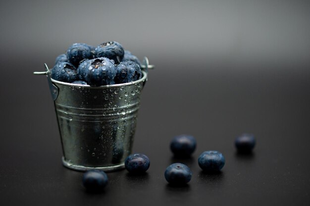 Closeup of a heap of fresh blueberries in a small bucket