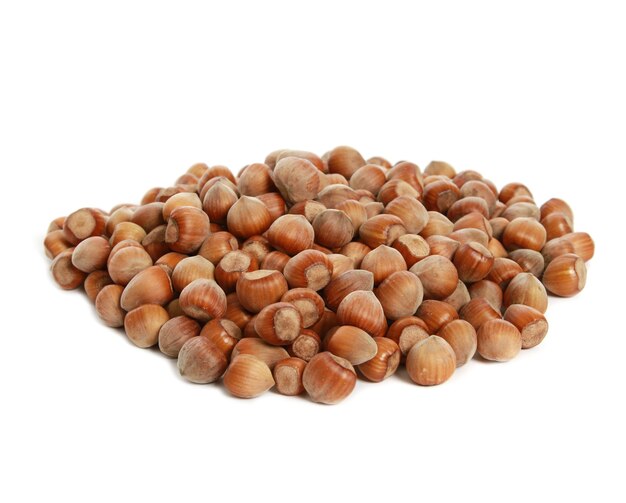 Closeup of a heap of hazelnuts isolated on white wall