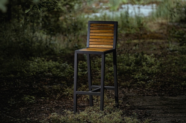 Closeup of a high loft-style chair in the evening garden