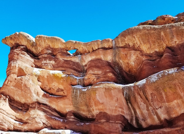 Closeup of high rocks in a desert with amazing textures and a blue sky