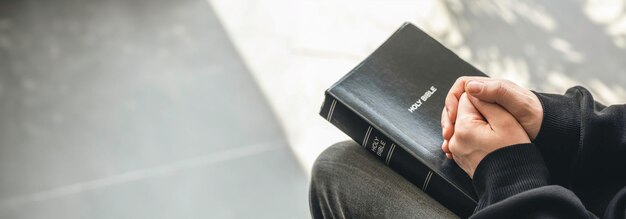 Closeup holy bible book in male hands