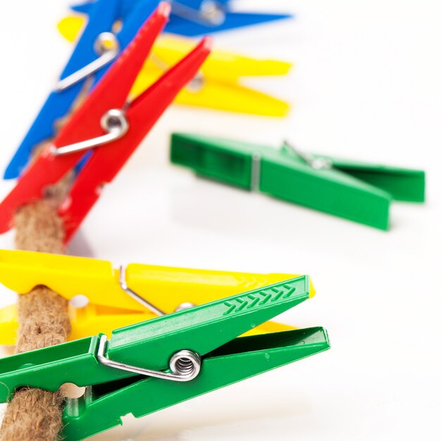 Closeup image of colorful clothespins on a cord