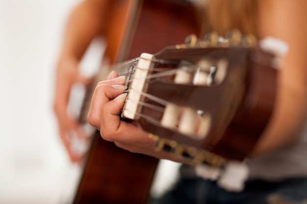 Closeup image of guitar in woman hands