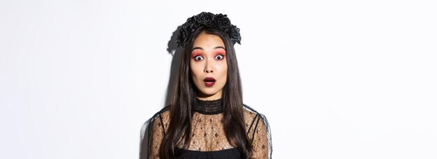 Closeup of impressed and shocked asian woman in halloween costume drop jaw and gasping wondered stan