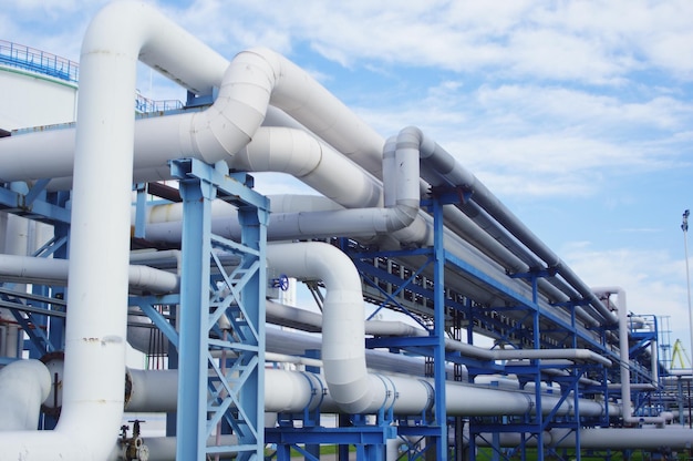 Closeup of industrial pipelines around a factor on a sunny day