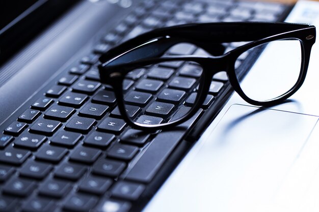 Closeup of a keyboard and glasses