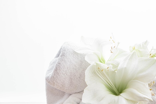 Free photo closeup lily flowers and a towel on a white background isolated