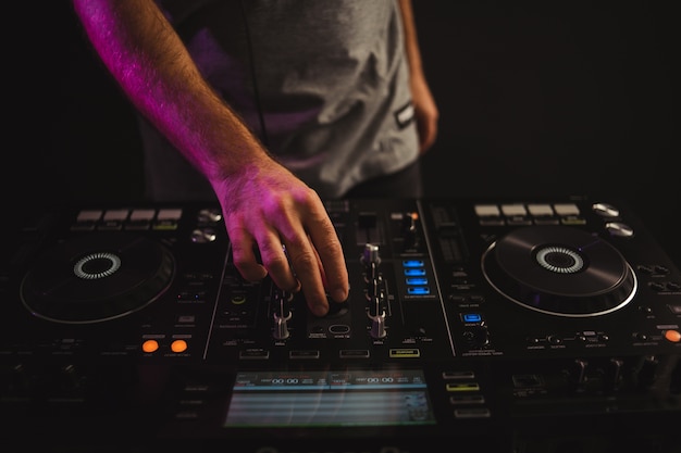 Closeup of a male DJ working in studio