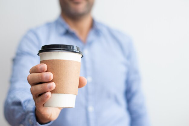 Closeup of man holding disposable cup